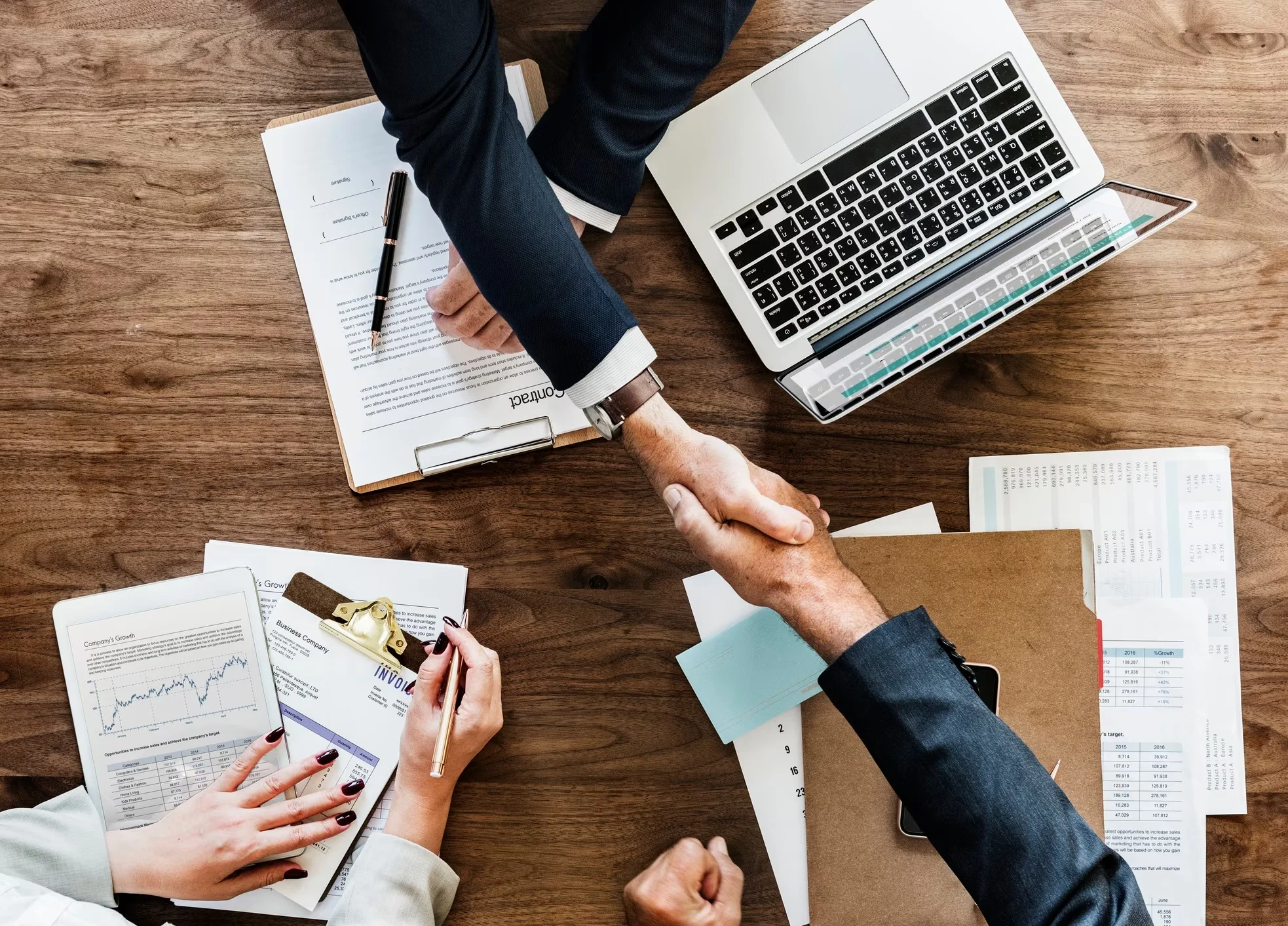 business people shaking hands together